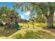 Large backyard with playset and mature trees at 1203 Waverly Way, Longwood, FL 32750