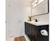 Modern bathroom with dark vanity and a large mirror at 1203 Waverly Way, Longwood, FL 32750