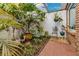 Lush courtyard with tropical plants and brick flooring at 1203 Waverly Way, Longwood, FL 32750