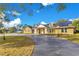 Attractive home with solar panels and a circular driveway, showcasing curb appeal at 1203 Waverly Way, Longwood, FL 32750