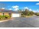 Attached garage with white door and solar panels on the roof at 1203 Waverly Way, Longwood, FL 32750