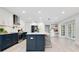 Updated kitchen with white and blue cabinets and quartz countertops at 1203 Waverly Way, Longwood, FL 32750