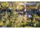 Aerial view of a property with mature trees and a red car in the driveway at 1222 Golfview St, Orlando, FL 32804