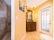 Bathroom vanity with neutral stone floors, bright yellow walls and decorative mirror at 1222 Golfview St, Orlando, FL 32804