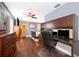 Home office bedroom with hardwood floors, ceiling fan and a dark, decorative desk at 1222 Golfview St, Orlando, FL 32804