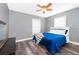 Bedroom with blue comforter, light gray walls, ceiling fan and large window at 1222 Golfview St, Orlando, FL 32804