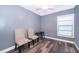 Bedroom with gray walls, dark wood floors, ceiling fan and large window allowing ample light at 1222 Golfview St, Orlando, FL 32804