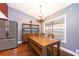 Dining area features hardwood floors, built-in cabinet, modern chandelier and window with blinds at 1222 Golfview St, Orlando, FL 32804