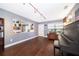 Cozy living room with hardwood floors, a piano, a comfy chair, and a built-in bookcase at 1222 Golfview St, Orlando, FL 32804