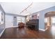 Bright living room with hardwood floors, piano and comfortable seating creating a welcoming atmosphere at 1222 Golfview St, Orlando, FL 32804