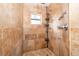 Bathroom shower featuring stone tiles and chrome fixtures at 1222 Golfview St, Orlando, FL 32804