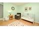 Bedroom with crib, armchair, and soft rug at 127 Kaywood Dr, Sanford, FL 32771