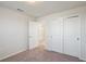 Bright bedroom with carpet, door to bathroom and double door closet at 1274 Shoreside St, Clermont, FL 34714