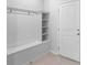 White entryway with built-in bench, hooks, and shelving at 1274 Shoreside St, Clermont, FL 34714