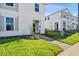 Two-story house with gray siding, landscaping, and a paved walkway at 1274 Shoreside St, Clermont, FL 34714