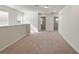 Bright loft with carpet flooring, access to bedrooms and a hallway at 1274 Shoreside St, Clermont, FL 34714