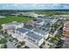 Wide aerial view showcasing the townhouses and surrounding area at 12964 Brandon Coates Dr, Orlando, FL 32828