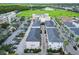 Aerial view of townhomes, parking, and surrounding area at 12964 Brandon Coates Dr, Orlando, FL 32828