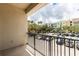 Private balcony overlooks a parking lot and residential area at 12964 Brandon Coates Dr, Orlando, FL 32828