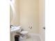 Small bathroom with a toilet and pedestal sink at 12964 Brandon Coates Dr, Orlando, FL 32828