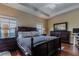 Spacious bedroom with a king-size bed and hardwood floors at 12964 Brandon Coates Dr, Orlando, FL 32828