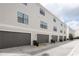 Gray garage doors and parking area for townhomes at 12964 Brandon Coates Dr, Orlando, FL 32828