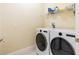 Bright laundry room, features washer, dryer, and shelving at 12964 Brandon Coates Dr, Orlando, FL 32828