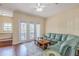 Spacious living room with hardwood floors and a comfy sectional sofa at 12964 Brandon Coates Dr, Orlando, FL 32828