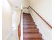 Dark wood staircase with simple white railing at 12964 Brandon Coates Dr, Orlando, FL 32828