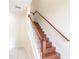 Elegant wooden staircase with white railings at 12964 Brandon Coates Dr, Orlando, FL 32828