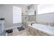 Spa-like bathroom with soaking tub, walk-in shower, and double vanity at 13214 Meergate Cir, Orlando, FL 32837