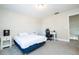 Bedroom with a bed, nightstand, and a workspace at 13214 Meergate Cir, Orlando, FL 32837