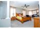 Large bedroom with wood bed frame and ceiling fan at 13214 Meergate Cir, Orlando, FL 32837