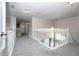 Upstairs hallway with carpeted floors and white railings at 13214 Meergate Cir, Orlando, FL 32837