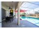 Screened patio with pool, outdoor dining area and TV at 13214 Meergate Cir, Orlando, FL 32837