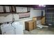 Unfinished basement with washer and dryer hookups and storage shelves at 1425 N Hiawassee Rd, Orlando, FL 32818