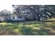 Ranch-style house with a large oak tree and expansive lawn at 1425 N Hiawassee Rd, Orlando, FL 32818