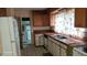 Galley kitchen with wood cabinets and tile countertops at 1425 N Hiawassee Rd, Orlando, FL 32818