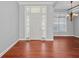 Bright entryway with hardwood floors and a classic white door at 1470 Place Picardy, Winter Park, FL 32789