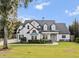 Elegant two-story house with white exterior, gray roof, and a manicured lawn at 1470 Place Picardy, Winter Park, FL 32789