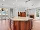 Large kitchen island with marble countertop and wooden cabinetry at 1470 Place Picardy, Winter Park, FL 32789