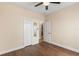 Bedroom with wood-look floors and double doors to closet at 15319 Stonebriar Way, Orlando, FL 32826