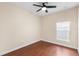 Simple bedroom with wood-look floors and a window at 15319 Stonebriar Way, Orlando, FL 32826