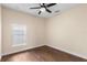 Well-lit bedroom featuring wood-look floors at 15319 Stonebriar Way, Orlando, FL 32826