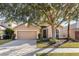 Attractive one-story home with a paved driveway and landscaping at 15319 Stonebriar Way, Orlando, FL 32826