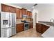 Modern kitchen with stainless steel appliances and wood cabinets at 15319 Stonebriar Way, Orlando, FL 32826