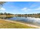 Peaceful pond view with homes in the background at 15319 Stonebriar Way, Orlando, FL 32826