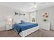 King bedroom with white bed frame and blue bedding at 1551 Flange Dr, Davenport, FL 33896