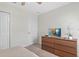 Bedroom with wood dresser, TV and ceiling fan at 1551 Flange Dr, Davenport, FL 33896