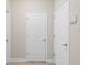 Hallway with neutral paint and white doors at 1551 Flange Dr, Davenport, FL 33896